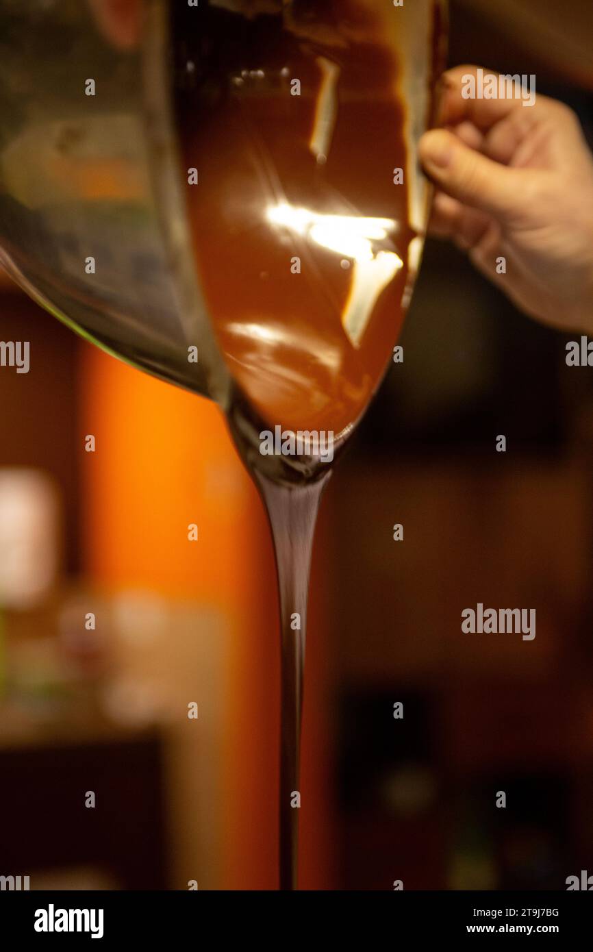 A Chocolatier Pouring Melted Chocolate Stock Photo