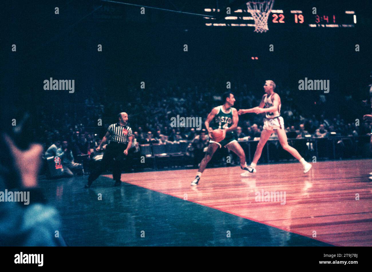 NEW YORK, NY - OCTOBER 25: Bob Cousy #14 of the Boston Celtics holds the ball as Kenny Sears #12 of the New York Knicks defends during an NBA game on October 25, 1958 at the Madison Square Garden in New York, New York.  (Photo by Hy Peskin) *** Local Caption *** Bob Cousy;Kenny Sears Stock Photo