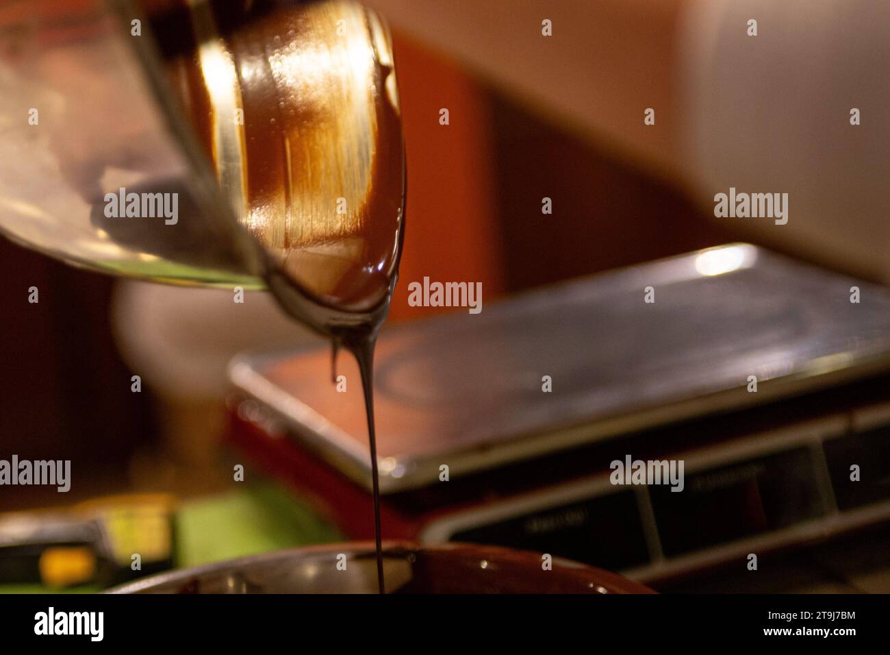 A Chocolatier Pouring Melted Chocolate Stock Photo