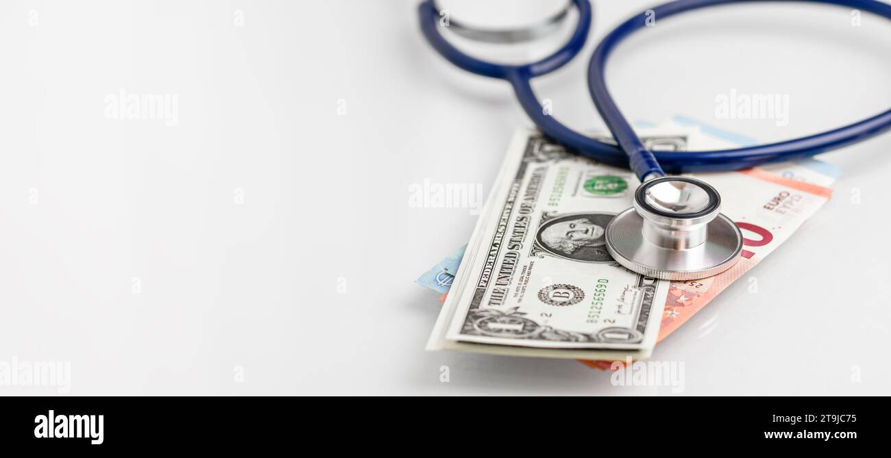 Stethoscope lying on various Euro and US banknotes. Medical cost, insurance, wealth, health, education concept. Stock Photo