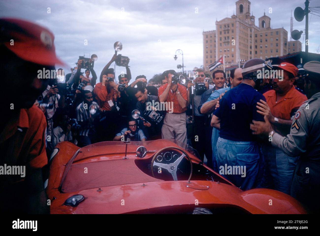 HAVANA, CUBA - FEBRUARY 24:  Juan Manuel Fangio (1911-1995) driver of the Maserati 300S climbs out of his car after the 1957 Cuban Grand Prix on February 24, 1957 in Havana, Cuba.  Fangio won the race.  (Photo by Hy Peskin) *** Local Caption *** Juan Manuel Fangio Stock Photo