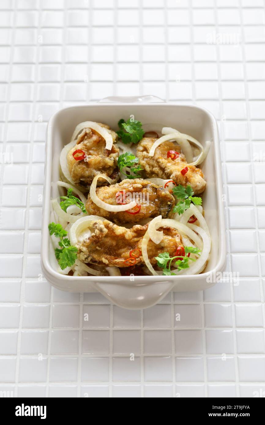 Oyster escabeche, battered and fried oysters marinated with vinegar