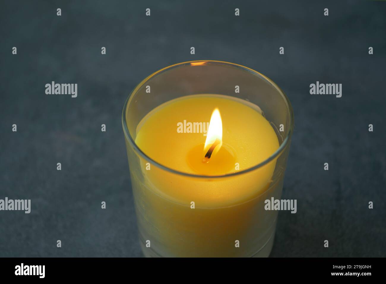 color candles slowly burning down in dark Stock Photo Alamy
