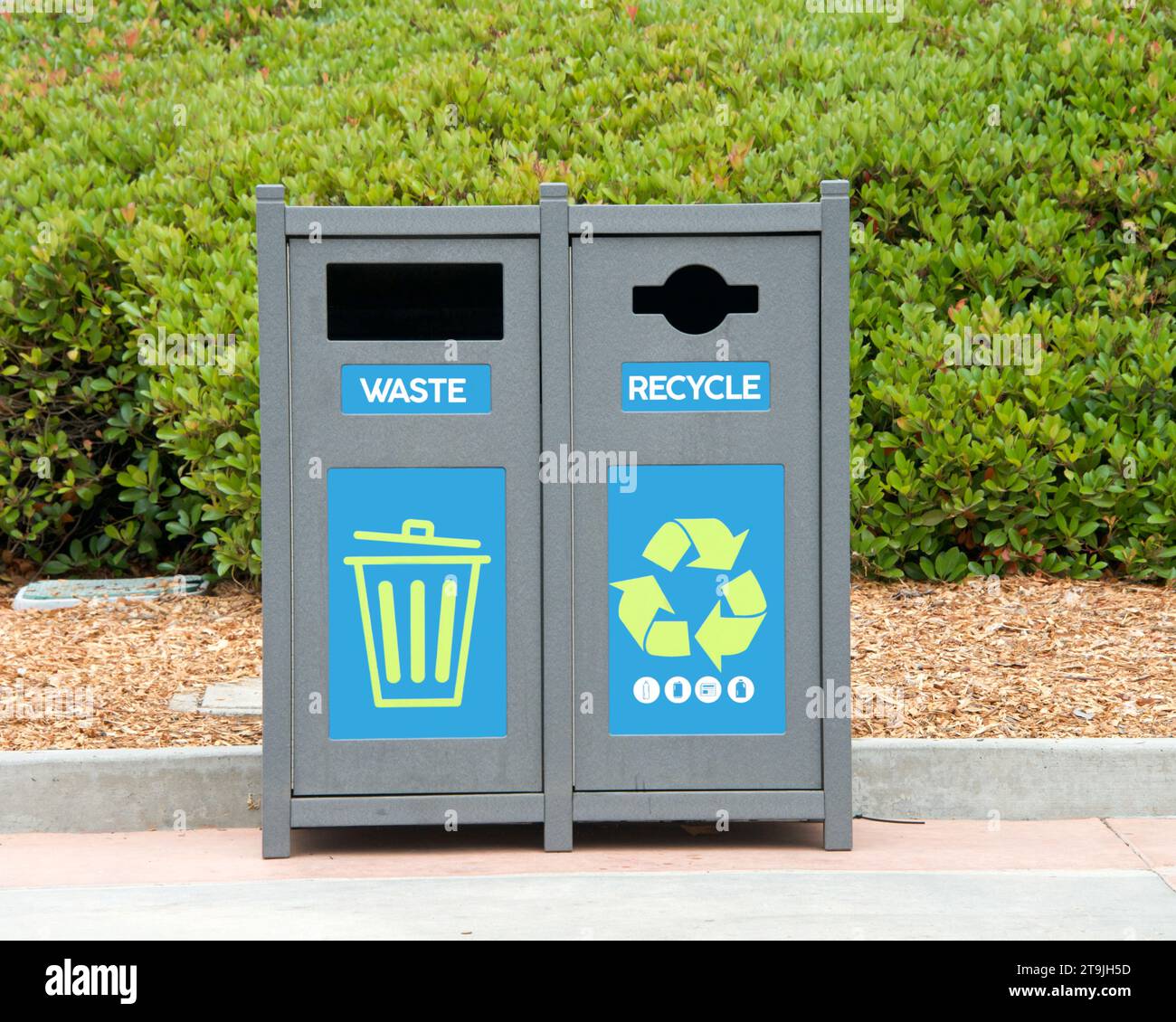 trash cans in a park with bushes in background. Landfill and Recycling