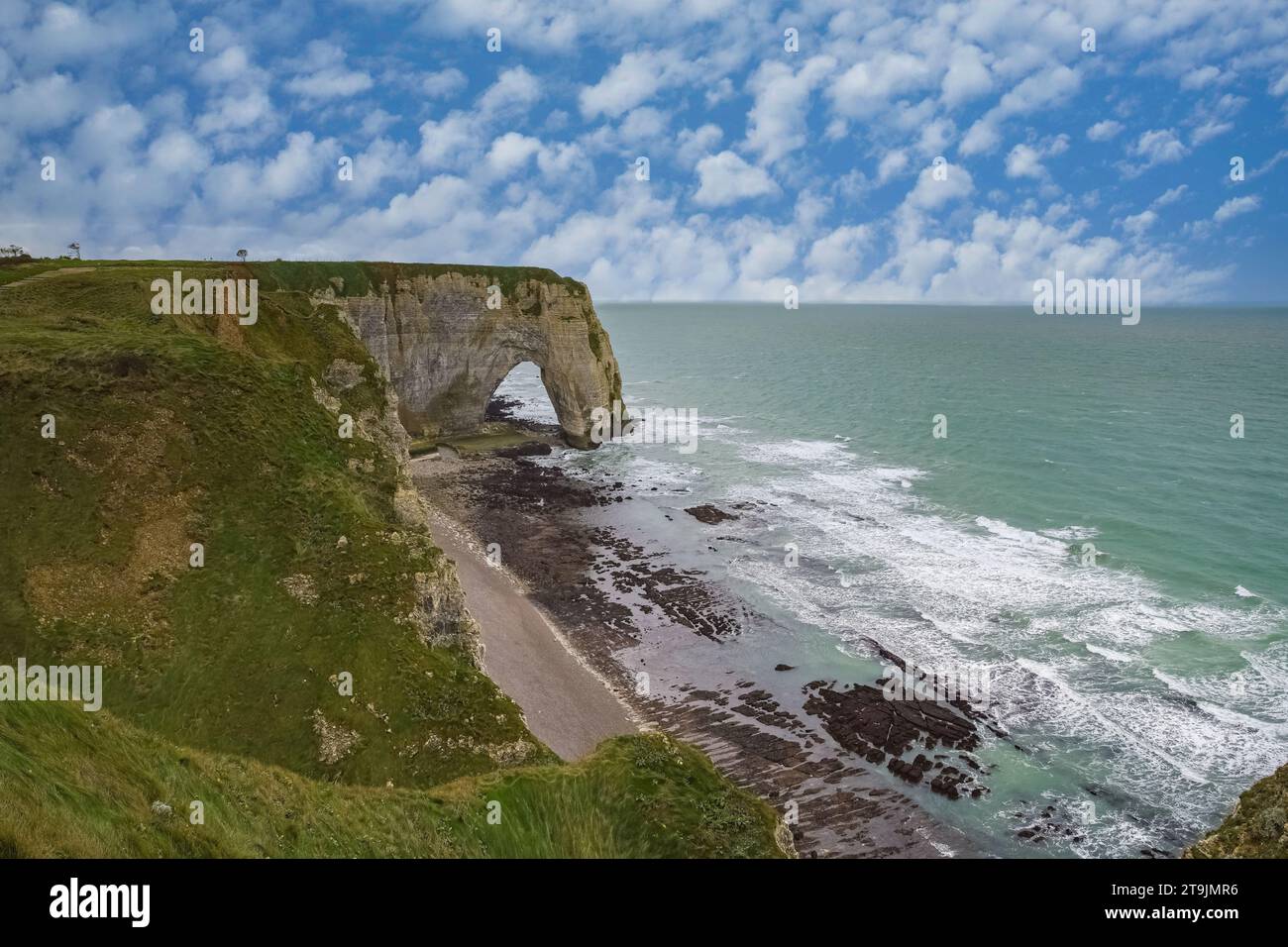 Etretat in Normandy, the famous cliffs and needle on the pebble beach ...