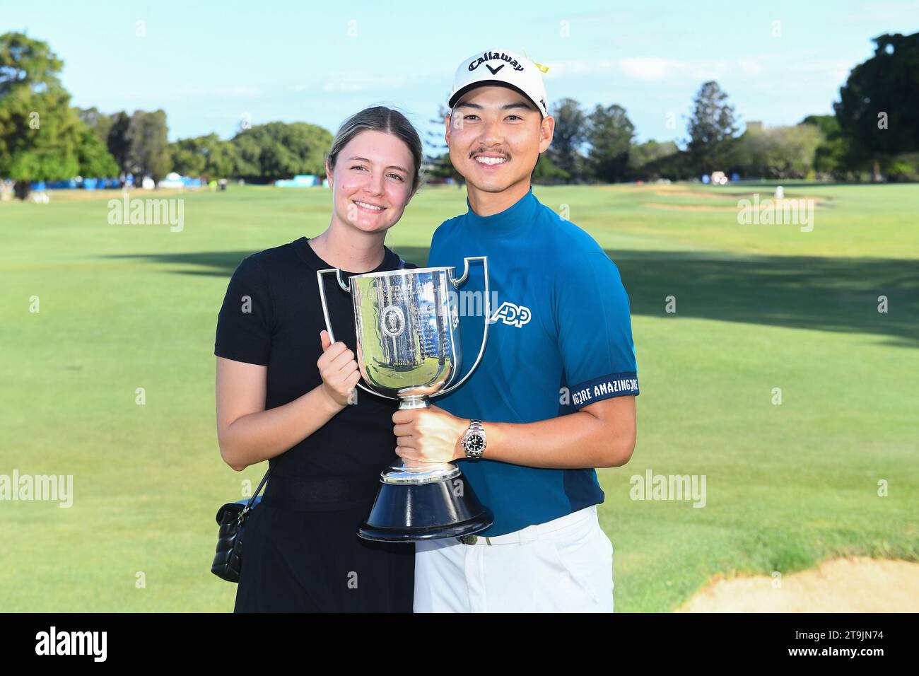 Brisbane, Australia. 26th Nov, 2023. Min Woo Lee (right) and girlfriend  Gracie Drennan celebrate winning the 2023 Australian PGA Championship in  Brisbane, Sunday, November 26, 2023. (AAP Image/Jono Searle) NO ARCHIVING,  EDITORIAL