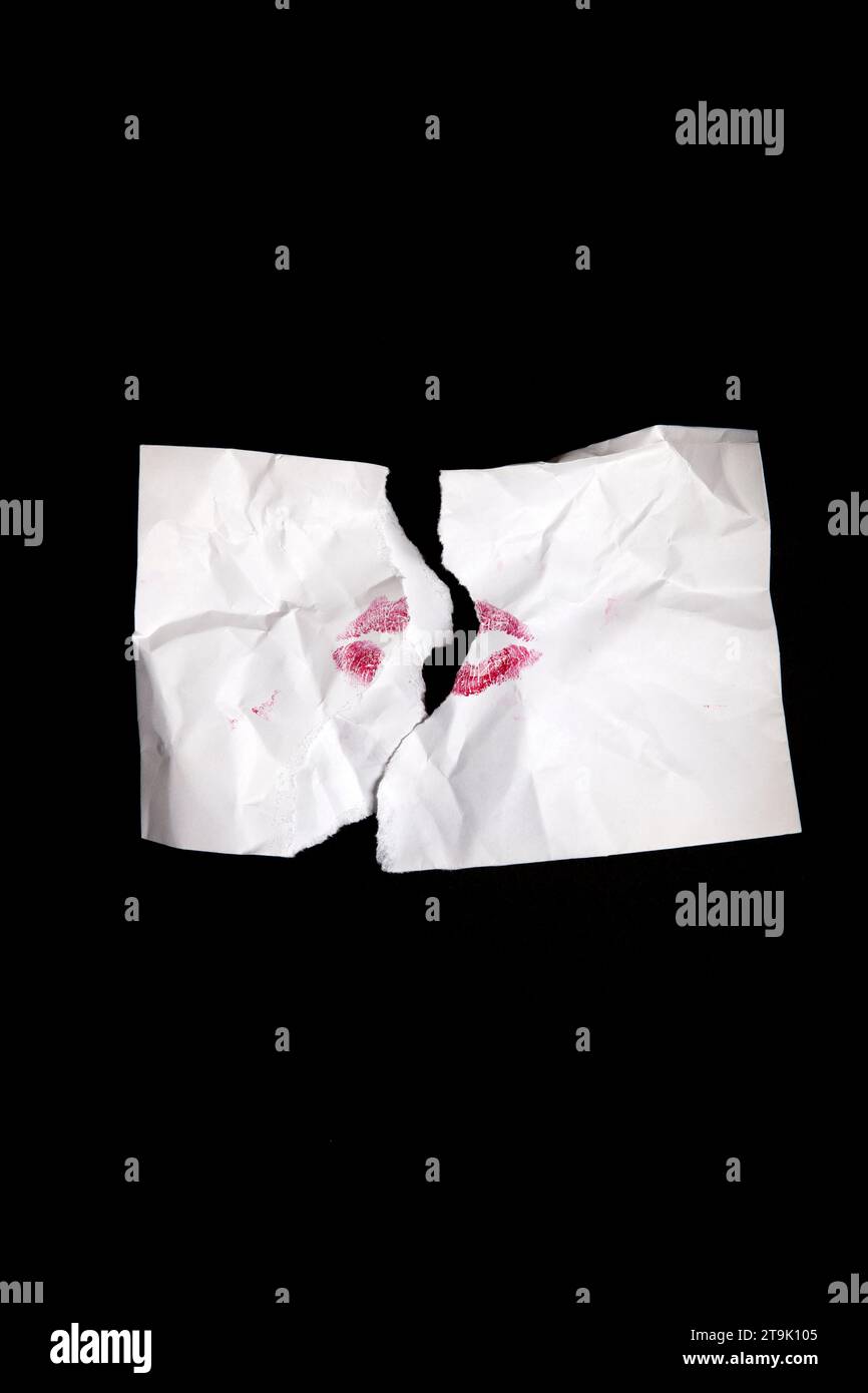 Torn White Envelope with Red Lipstick Kiss on Black Stock Photo