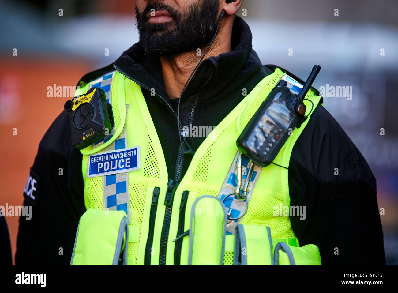 GMP Greater Manchester police radio, logo and cctv camera on Hi Visibility vest Stock Photo