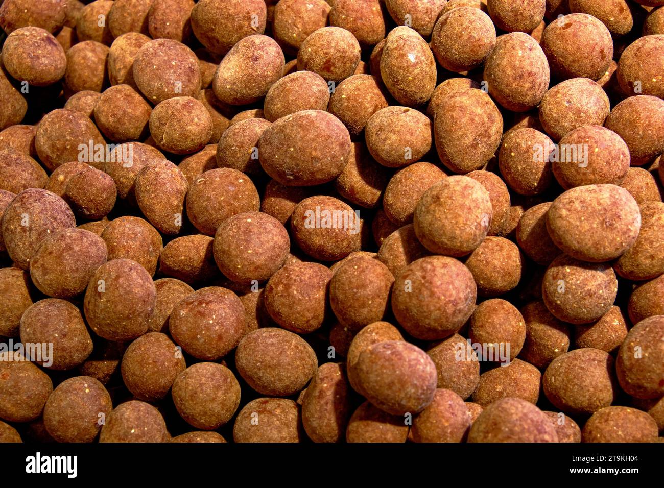 A pile of chocolate sweets as a background. Candy close-up. Stock Photo