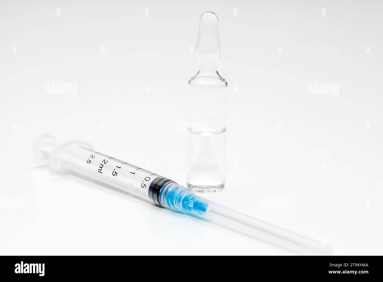Syringe, needle in cap, and glass ampoule with medicine Stock Photo Alamy