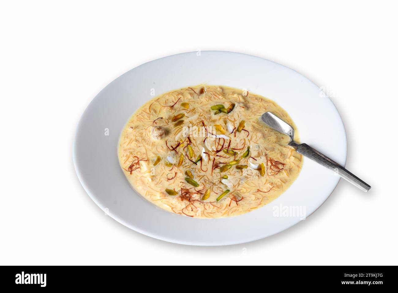 Sheer Khurma is prepared with milk and vermicelli, garnished with saffron, pistachios, and nuts. Stock Photo