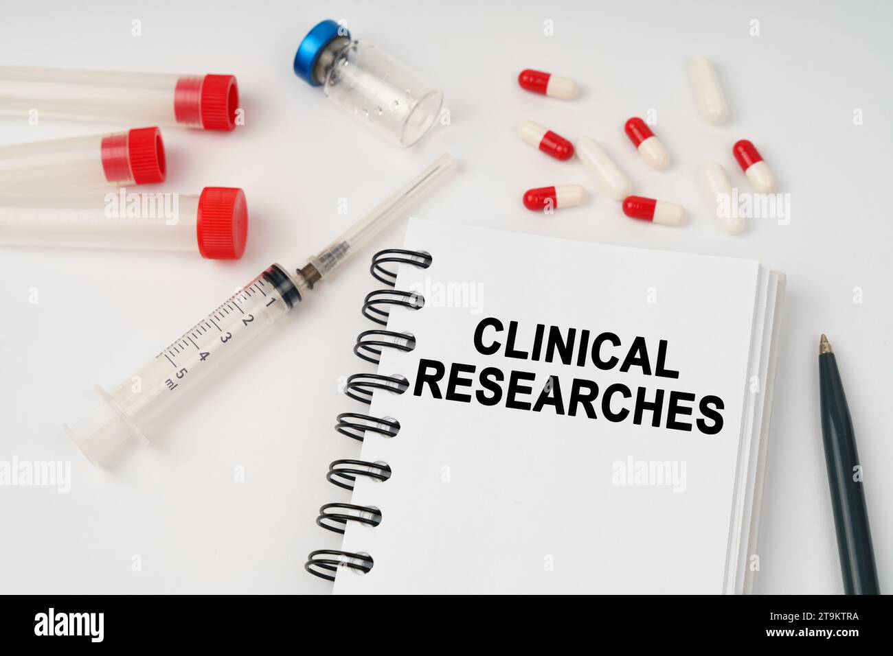Medical concept. On the table are pills, injections, a syringe and a notepad with the inscription - clinical researches Stock Photo