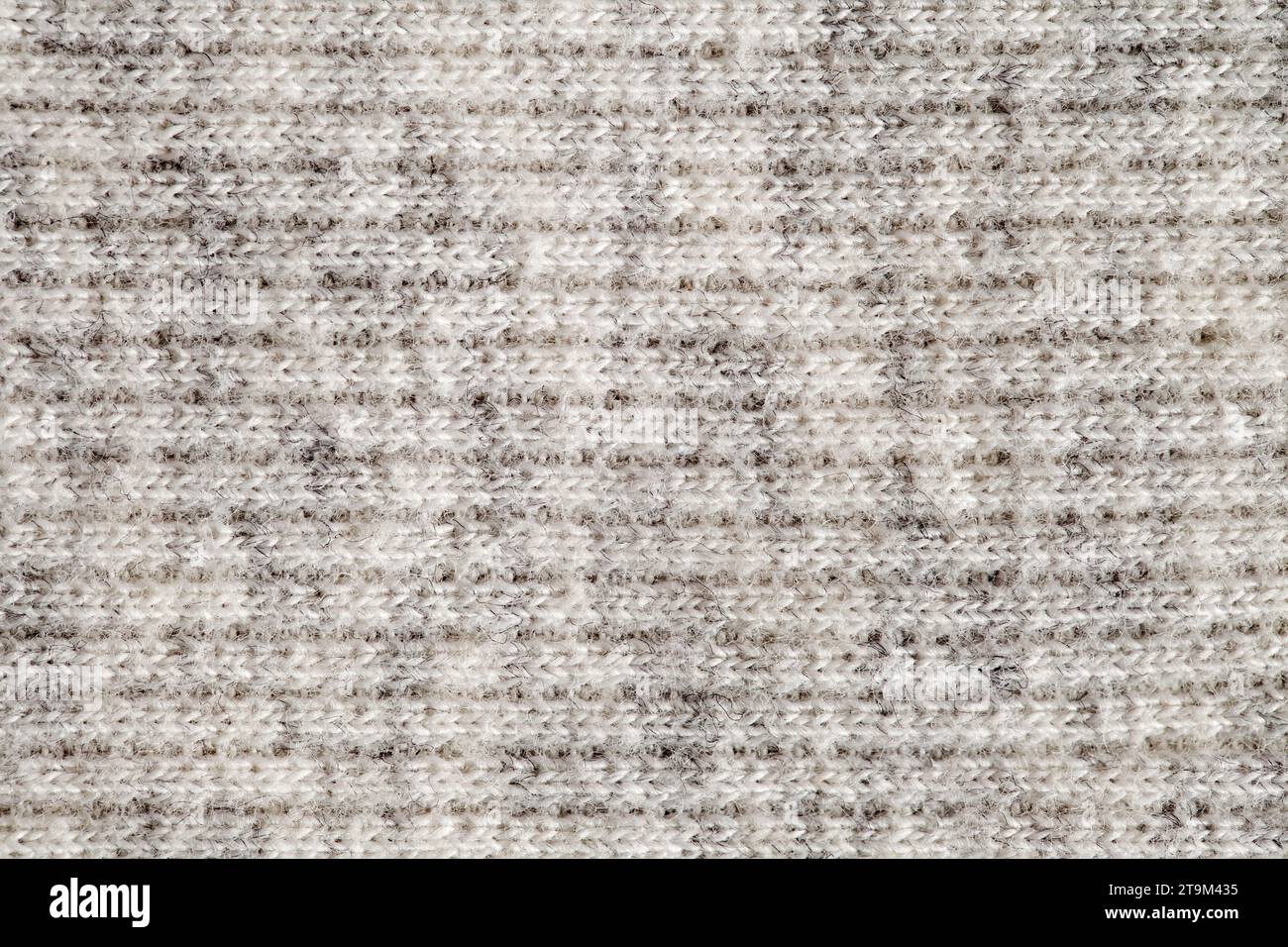 Wool yarn made of white threads, background structure, close-up macro view Stock Photo