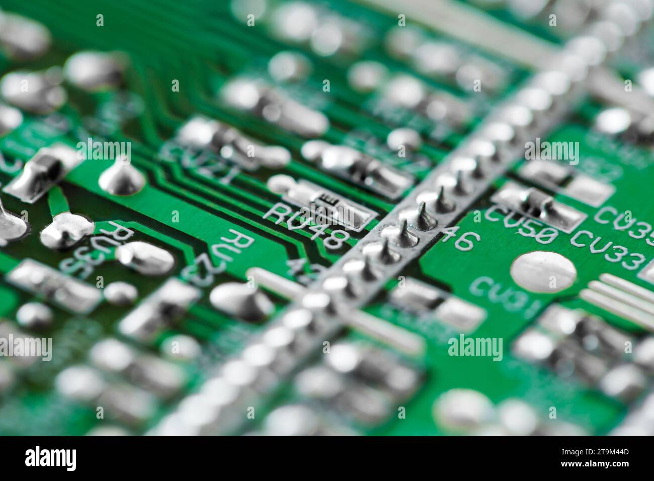 Printed electronic board with elements, green, close-up macro view, selective focus Stock Photo