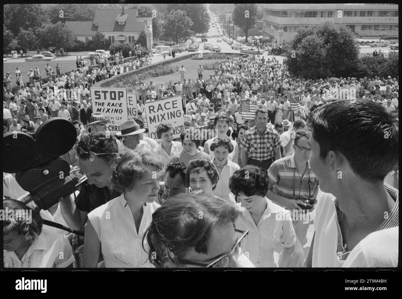 Large crowd gathered at the Arkansas State Capitol protesting the integration of Central High School, with signs reading 'Race mixing is Communism' and 'Stop the race mixing,' Little Rock, Arkansas, 8/20/1959. (Photo by John T BledsoeP Stock Photo