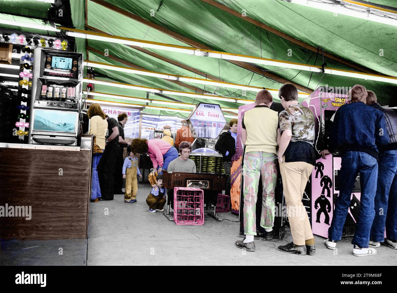 colourised bw photo of the Oval fair that came to Hastings most years. Space invaders was the latest in thing. Taken in 1979. Stock Photo