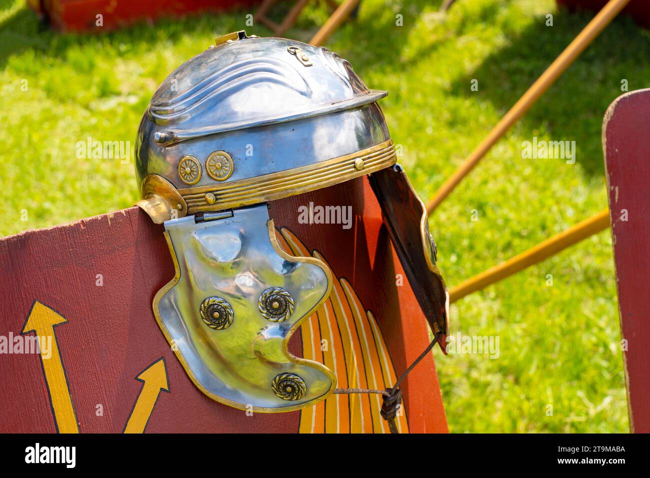 Ancient Roman legionary helmet on a red legionary shield Stock Photo