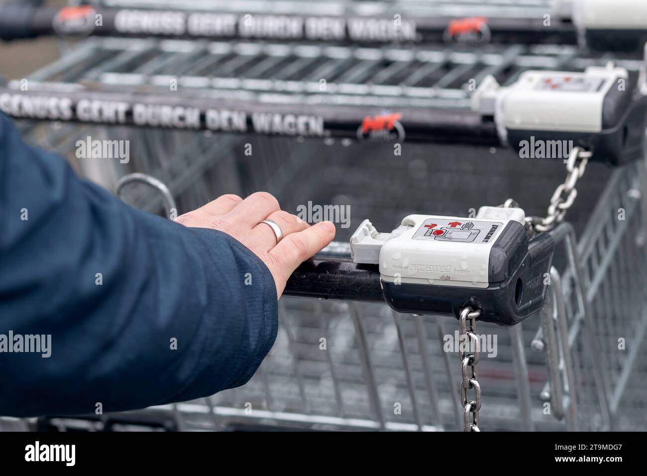 Bavaria, Germany - November 26, 2023: A man takes a shopping cart from a shopping cart box to go shopping *** Ein Mann nimmt einen Einkaufswagen aus einer Einkaufswagenbox zum Einkaufen Credit: Imago/Alamy Live News Stock Photo
