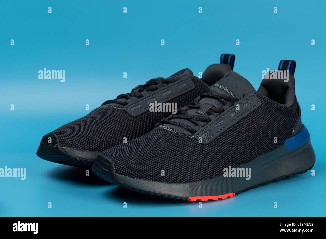 Pair of sport mesh shoes front view isolated on blue studio background Stock Photo