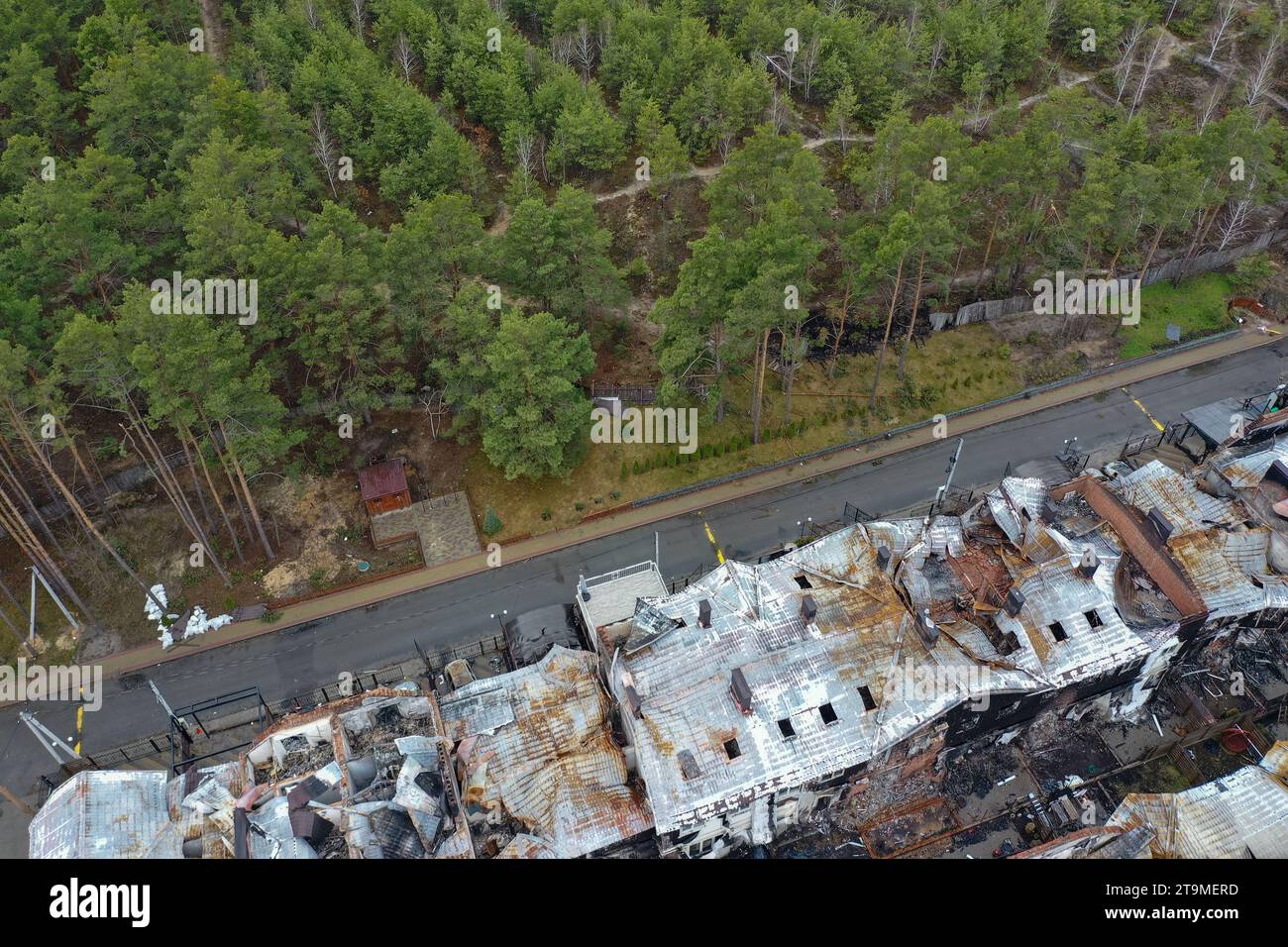 Hostomel, Kyev region Ukraine - 09.04.2022: Top view of the destroyed and burnt houses. Houses were destroyed by rockets or mines from Russian soldier Stock Photo