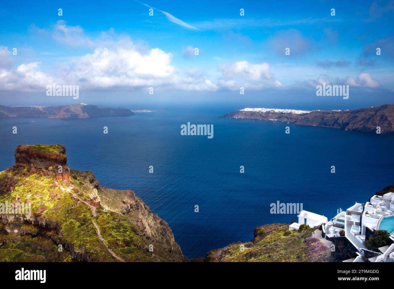 Skaros rock at Imerovigli with the village of Oia in the distance in Santorini, Greece. Stock Photo
