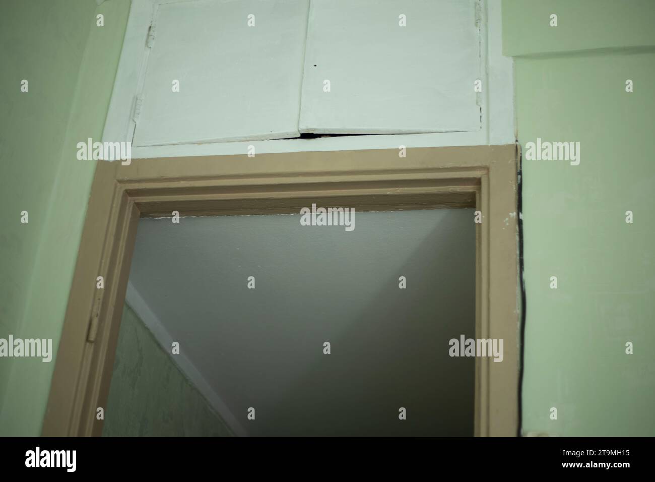 Doorway in the room. Storage room above the door. Details of the