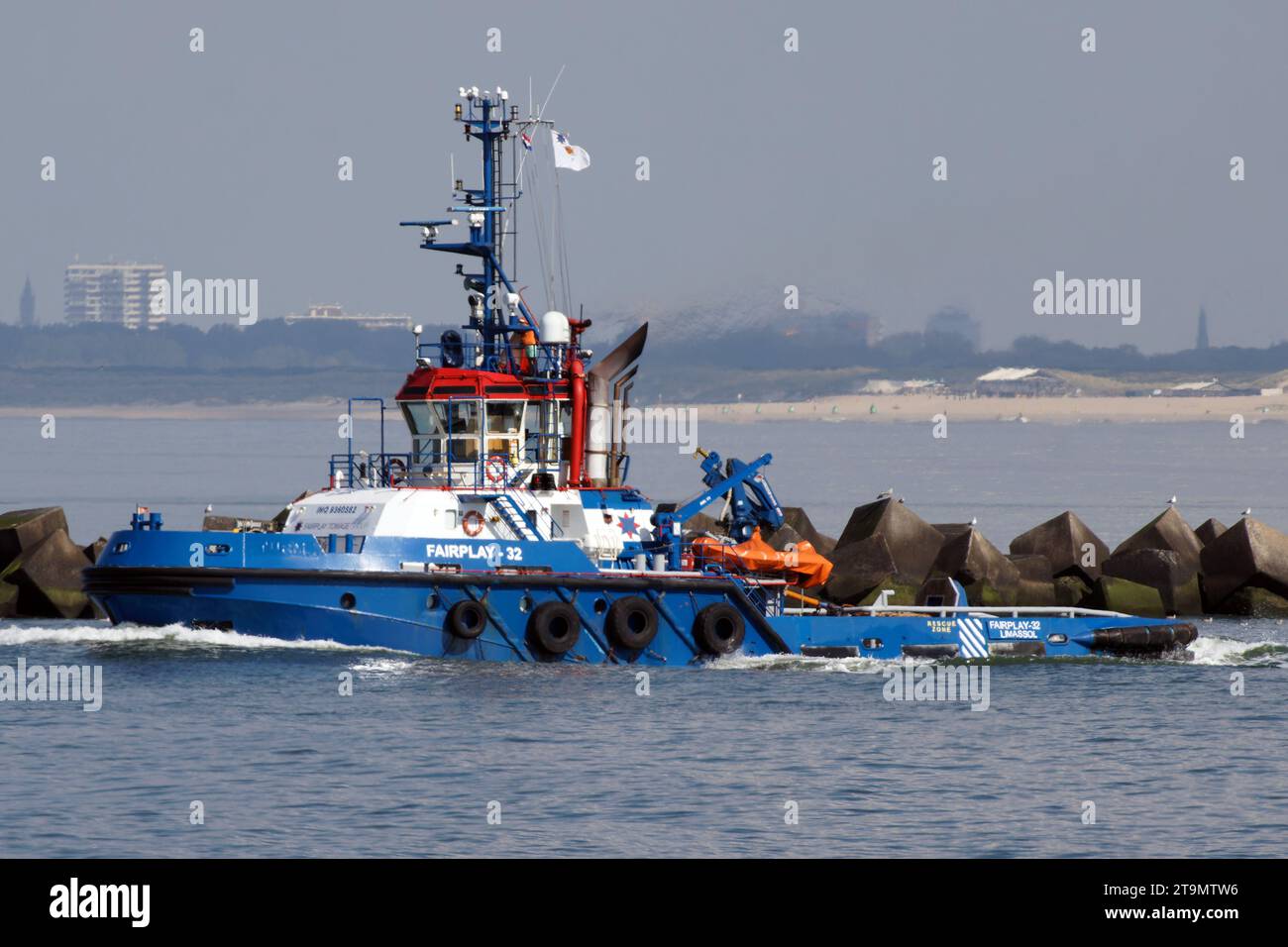 On September 14, 2023, the harbor tug Fairplay-32 works in the port of Rotterdam. Stock Photo