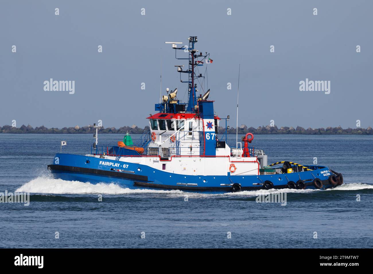 On September 14, 2023, the harbor tug Fairplay-67 works in the port of Rotterdam. Stock Photo