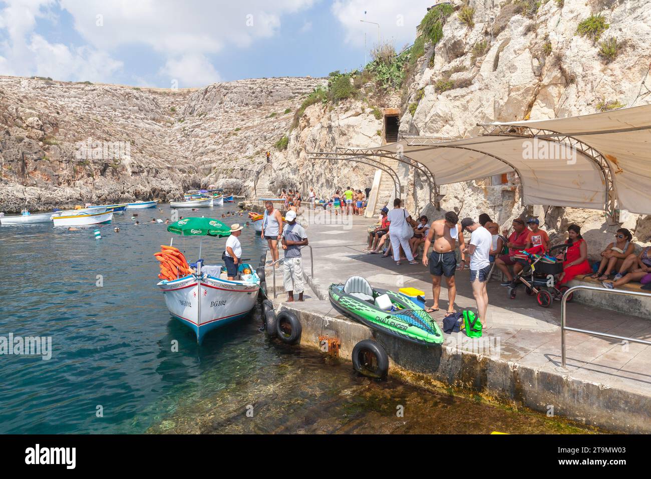 Blue Grotto, Malta - August 22, 2019: Tourists wait for a Blue Grotto boat trip departure on a sunny day Stock Photo