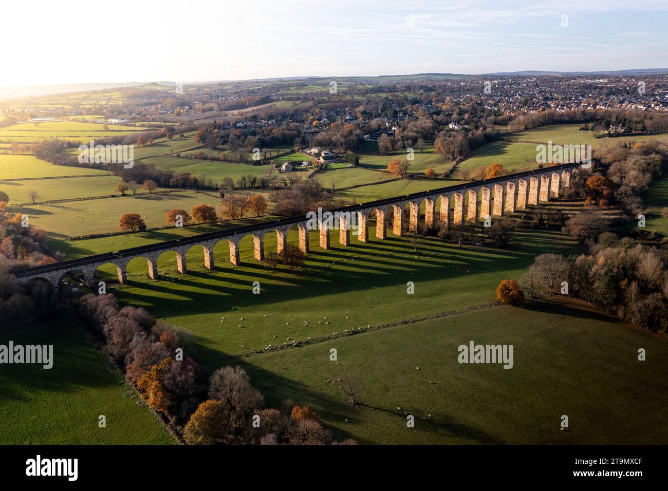 An aerial landscape high above the historic Crimple Valley Viaduct bridge with multiple arches near the Yorkshire Dales town of Harrogate at sunset Stock Photo