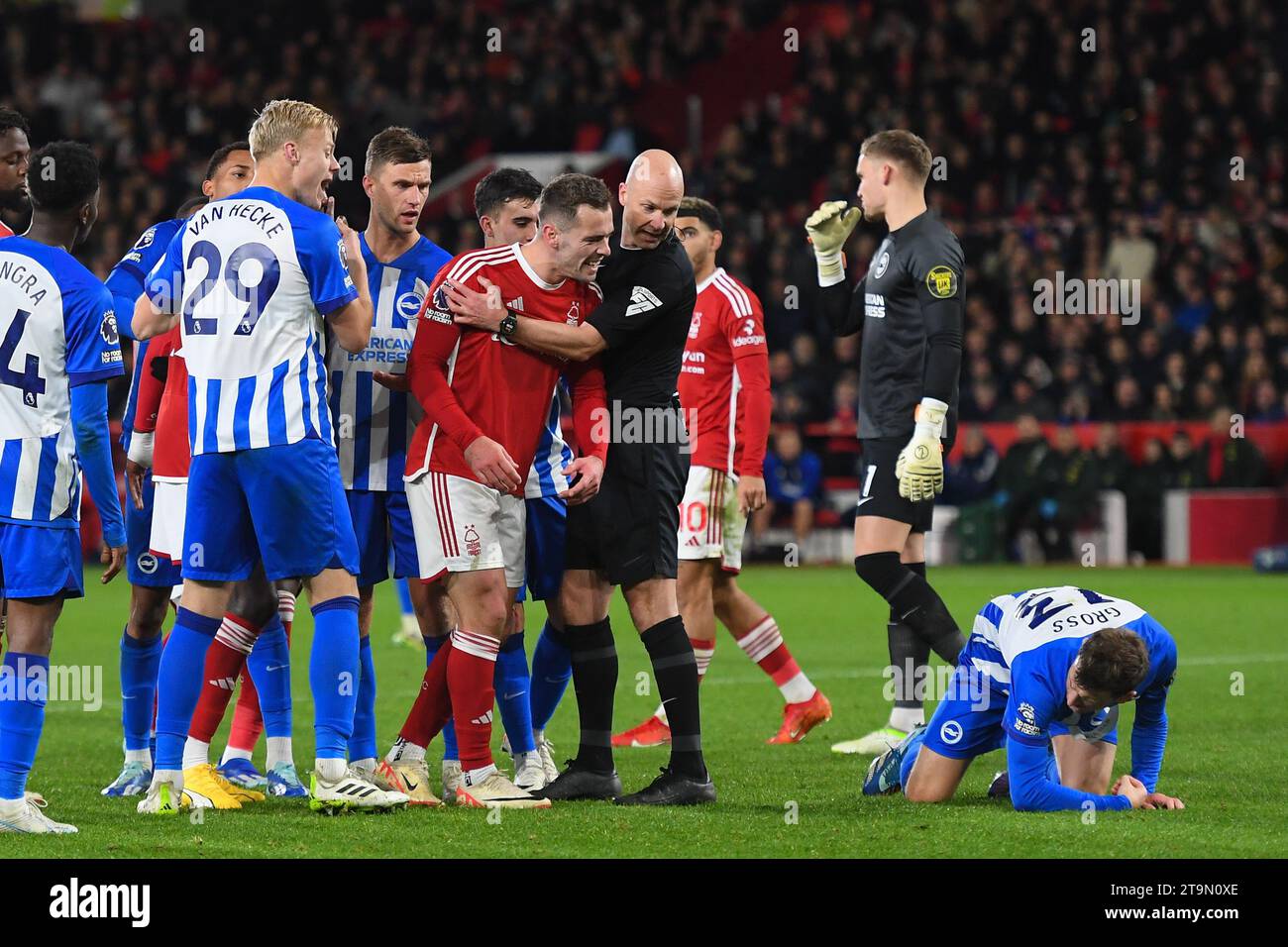 Referee, Anthony Taylor holds back Harry Toffolo of Nottingham Forest who shouts to Pascal Gross of Brighton during the Premier League match between Nottingham Forest and Brighton and Hove Albion at the City Ground, Nottingham on Saturday 25th November 2023. (Photo: Jon Hobley | MI News) Credit: MI News & Sport /Alamy Live News Stock Photo