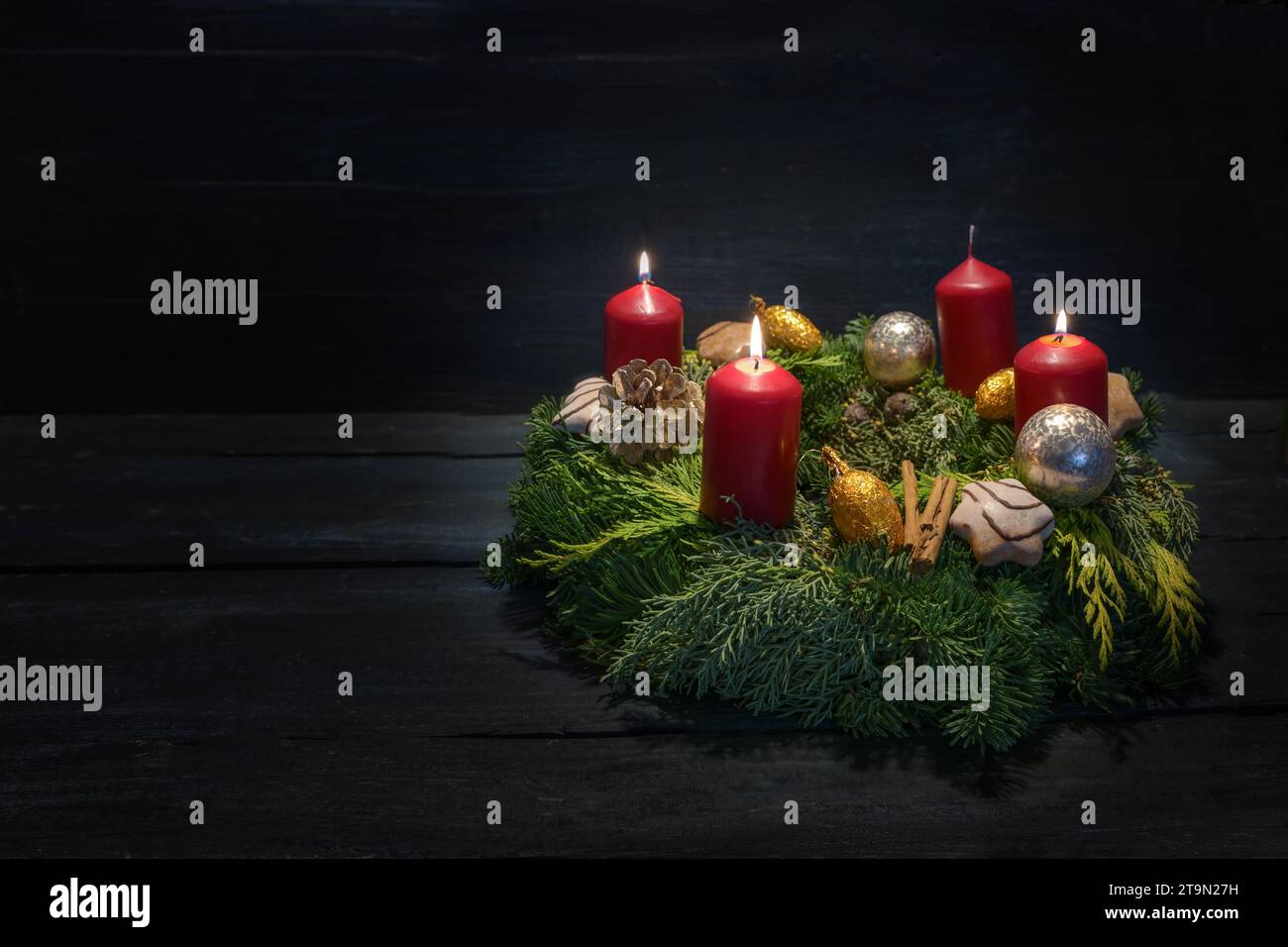 Light in the dark on third advent, natural green wreath with red