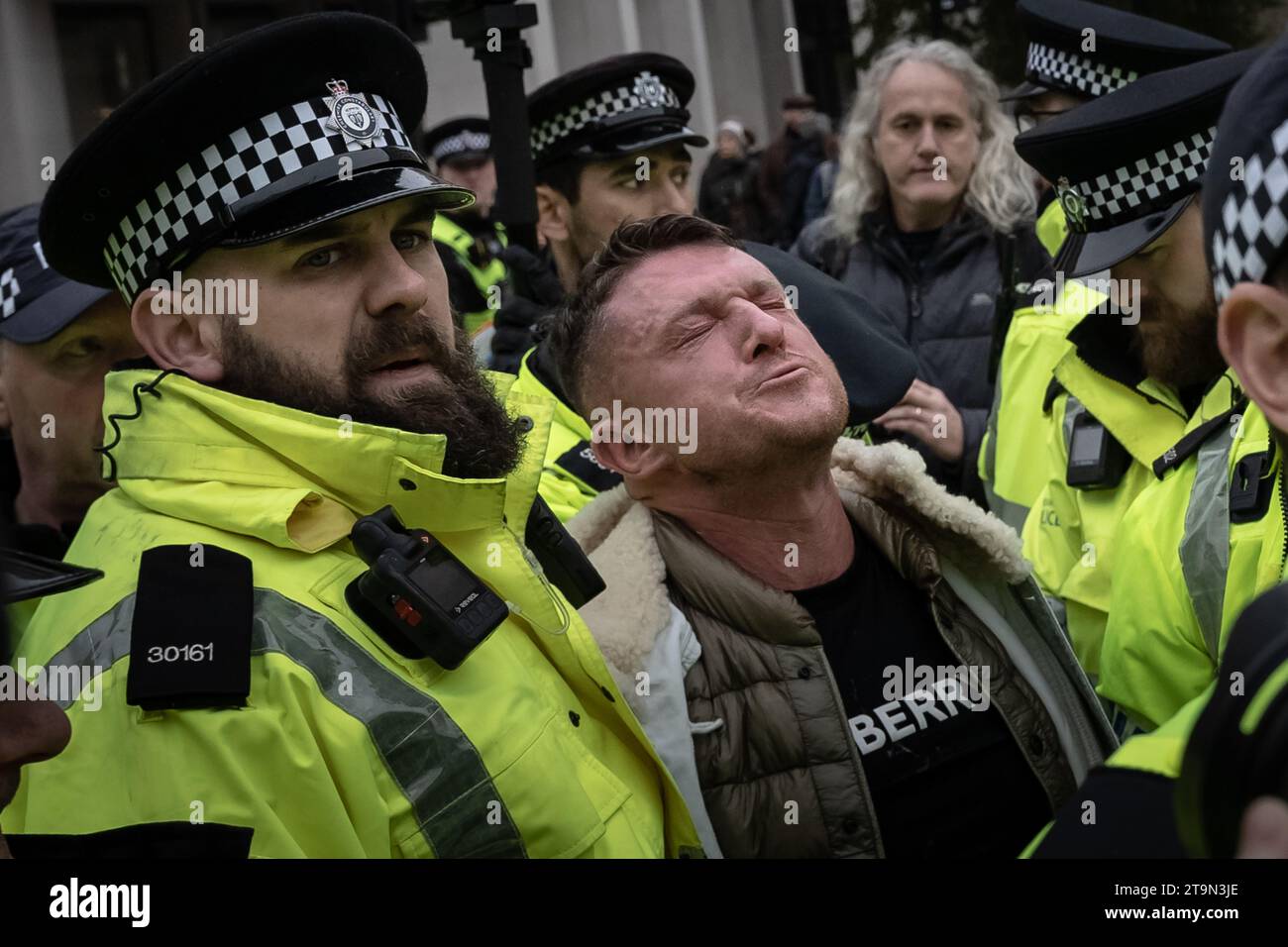 London, UK. 26th November 2023. Tommy Robinson is pepper sprayed and arrested by police officers prior to being asked to leave the March Against Antisemitism. The hard-right agitator was in a café opposite the Royal Courts of Justice, the official start point of the demonstration, when officers ordered him to leave over concerns that his presence would “cause harassment, alarm and distress to others”. Credit: Guy Corbishley/Alamy Live News Stock Photo