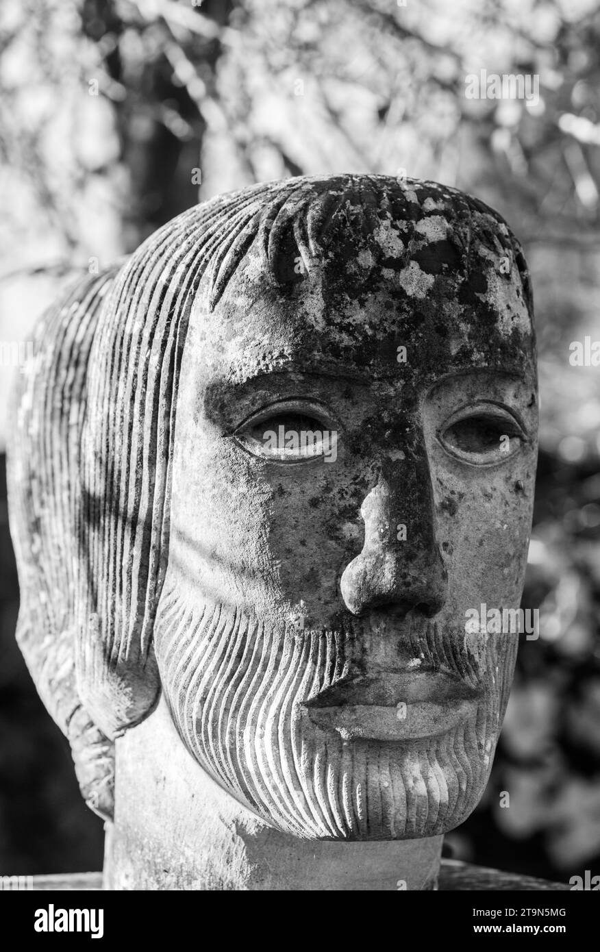 One of the faces of the Janus statue by John Skelton (1997) in Southover Grange Gardens, Lewes, East Sussex Stock Photo