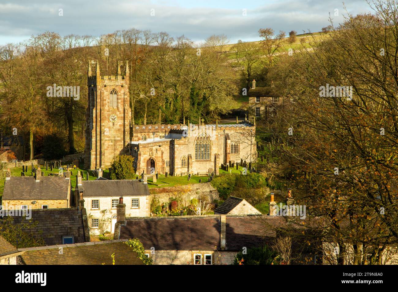 View over the Derbyshire Peak District village of Hartington with a view of Saint Giles church and country cottages during Autumn Stock Photo