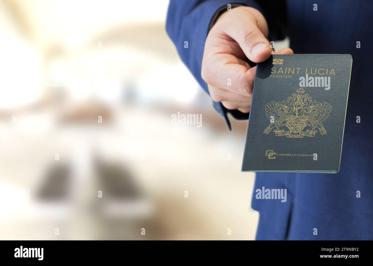 Hand holding new Saint Lucia passport, investment in passport Stock Photo