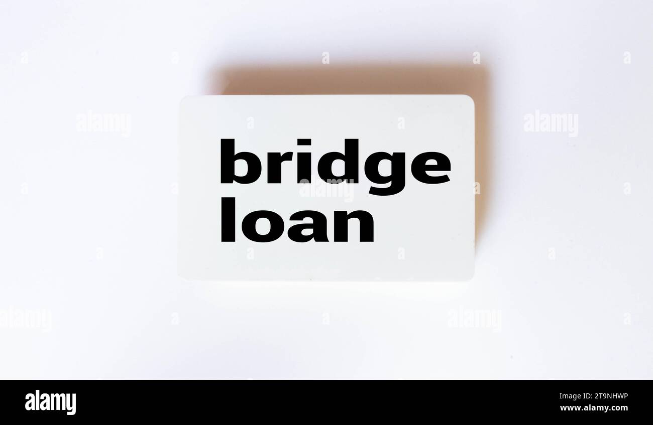 BRIDGE LOAN text on a notebook with clipboard and calculator on a chart