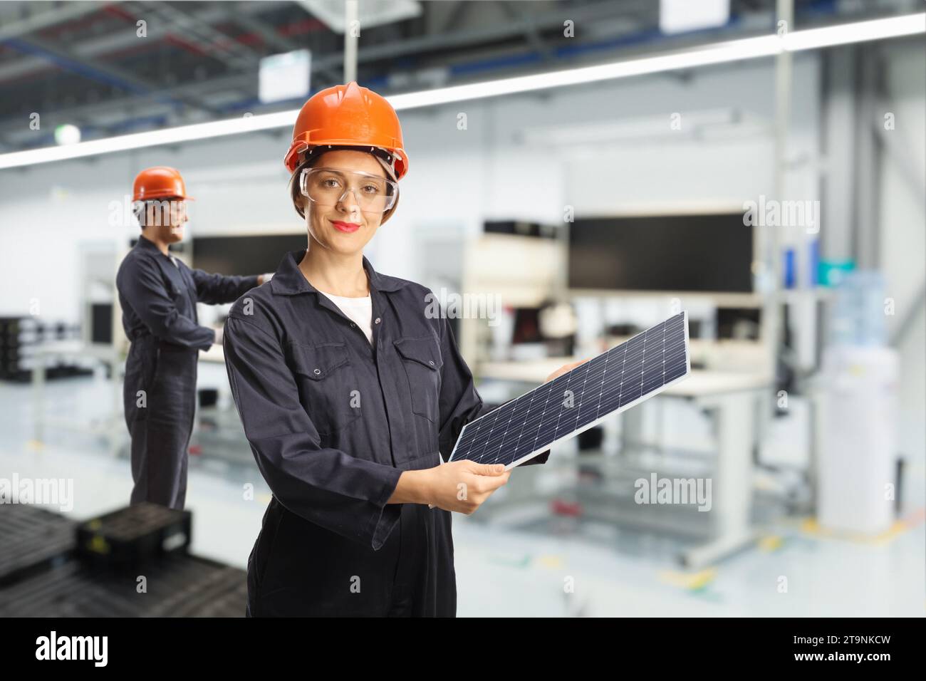 Solar panel production line, female worker in a factory Stock Photo
