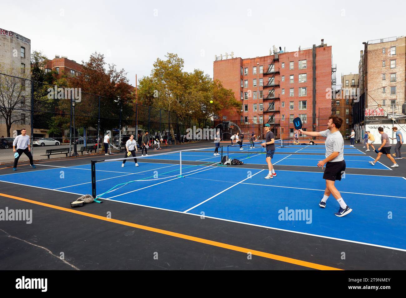 People playing pickleball on freshly painted, renovated courts at William F. Passannante Ballfield in Manhattan's Greenwich Village in New York City. Stock Photo