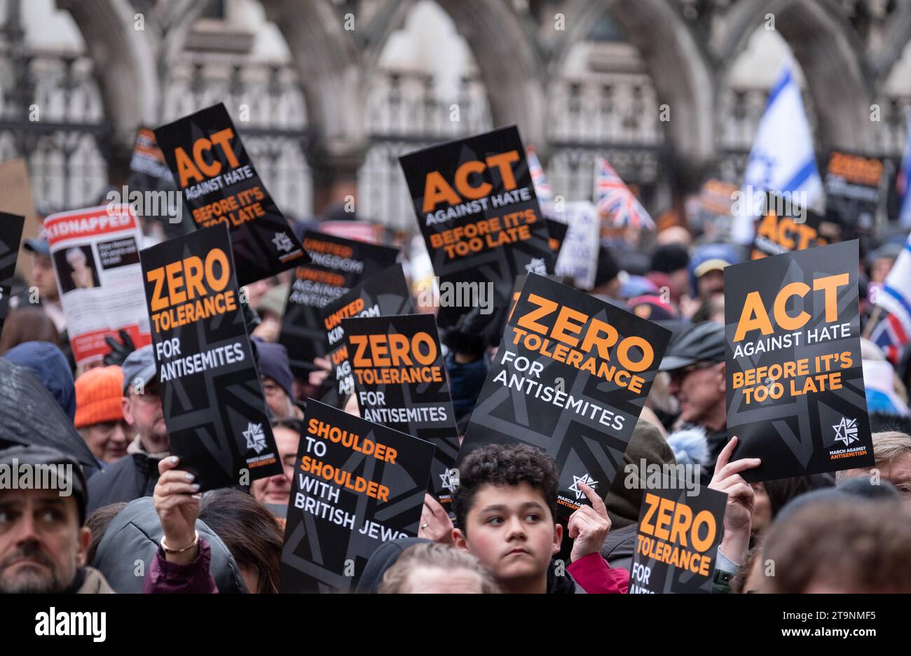 Crowds of people holding banners and flags aloft, at the March Against ...