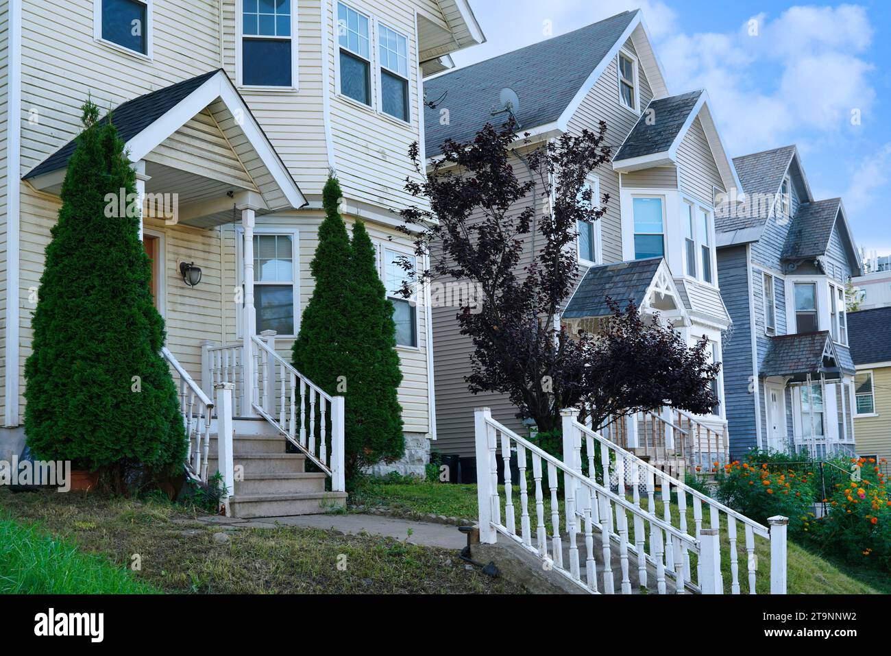 Row of tall narrow detached houses with gables Stock Photo