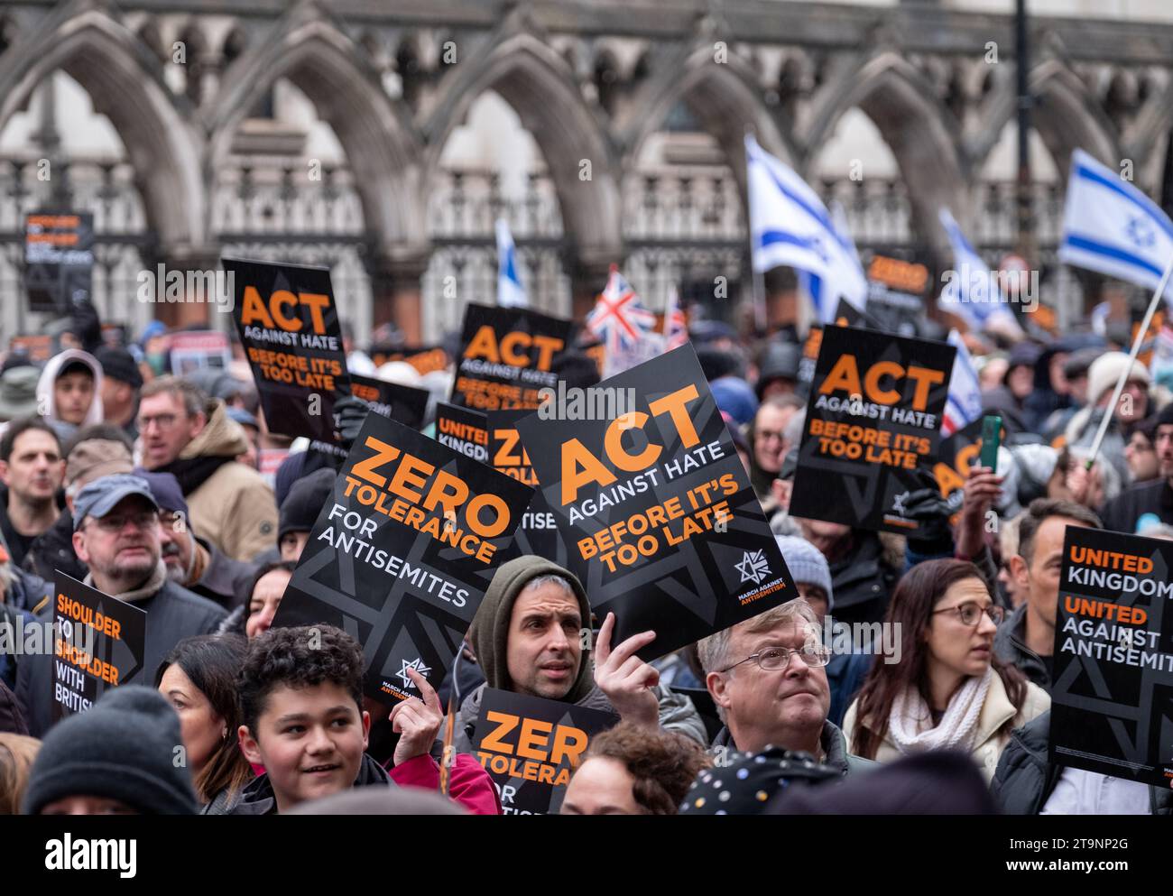 Crowds of people holding banners and flags aloft, at the March Against ...