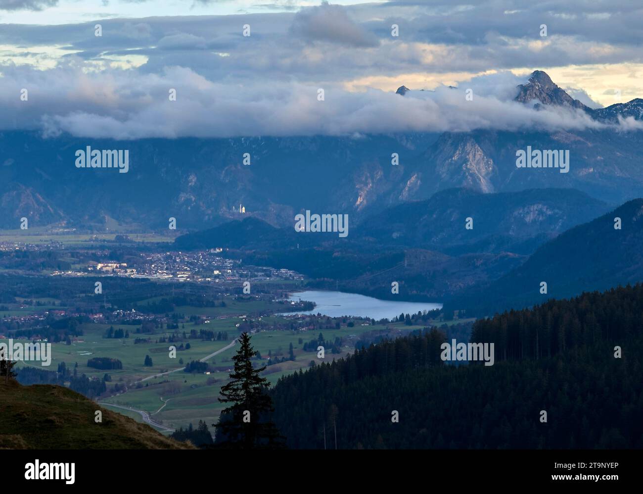 Hiker walking up to Edelsberg peak with Sportheim Böck mountain hut and a view on Weissensee an Neuschwanstein castle in Nesselwang, Germany, Nov 20, 2023. Credit: Imago/Alamy Live News Stock Photo