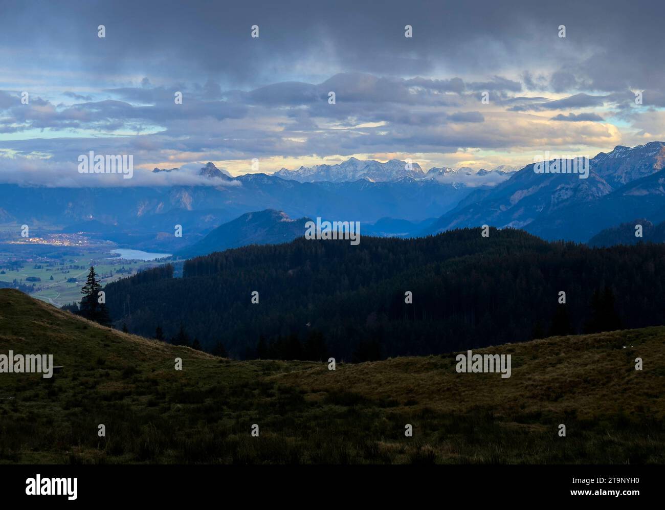 Hiker walking up to Edelsberg peak with Sportheim Böck mountain hut and a view on Weissensee an Neuschwanstein castle in Nesselwang, Germany, Nov 20, 2023. Credit: Imago/Alamy Live News Stock Photo