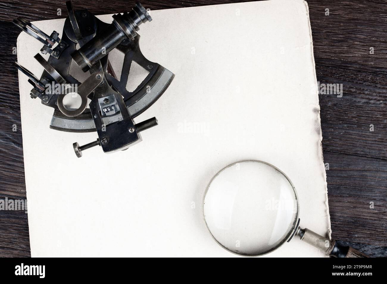 Antique naval brass sextant on old paper background Stock Photo Alamy