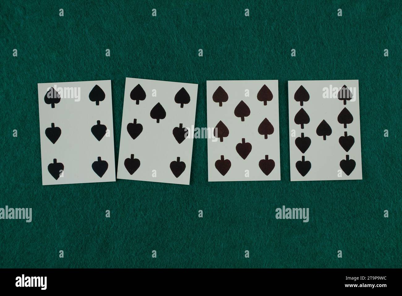 Old west era playing card on green gambling table. 6, 7, 8, 9 of spades. Stock Photo