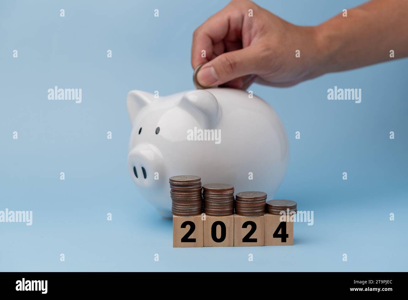 hand putting coin piggy bank and stack coin cube wood 2024 on ...