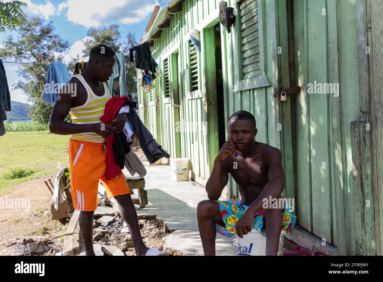 El Seibo, Dominican Republic. 21st Nov, 2023. Two residents of a batey, or community, chat while cleaning their clothes in El Seibo, Dominican Republic on Nov. 21, 2023. Most residents of these communities are either undocumented Haitian immigrants or denationalized Dominicans of Haitian descent. The United States blocked the Central Romana Corporation, Ltd. from importing sugar into the country on Nov. 23, 2022 after allegations of forced labor were levied against the company. (Photo by Carlos Berríos Polanco/Sipa USA) Credit: Sipa USA/Alamy Live News Stock Photo