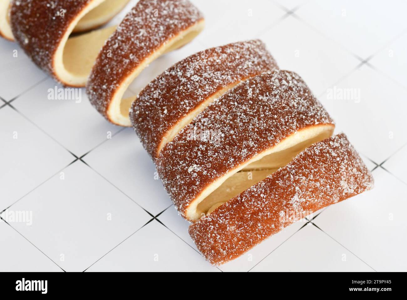 Close up of 'Kurtoskalacs', a spit cake with sugar from Hungary and Romania made from sweet yeast dough strips Stock Photo