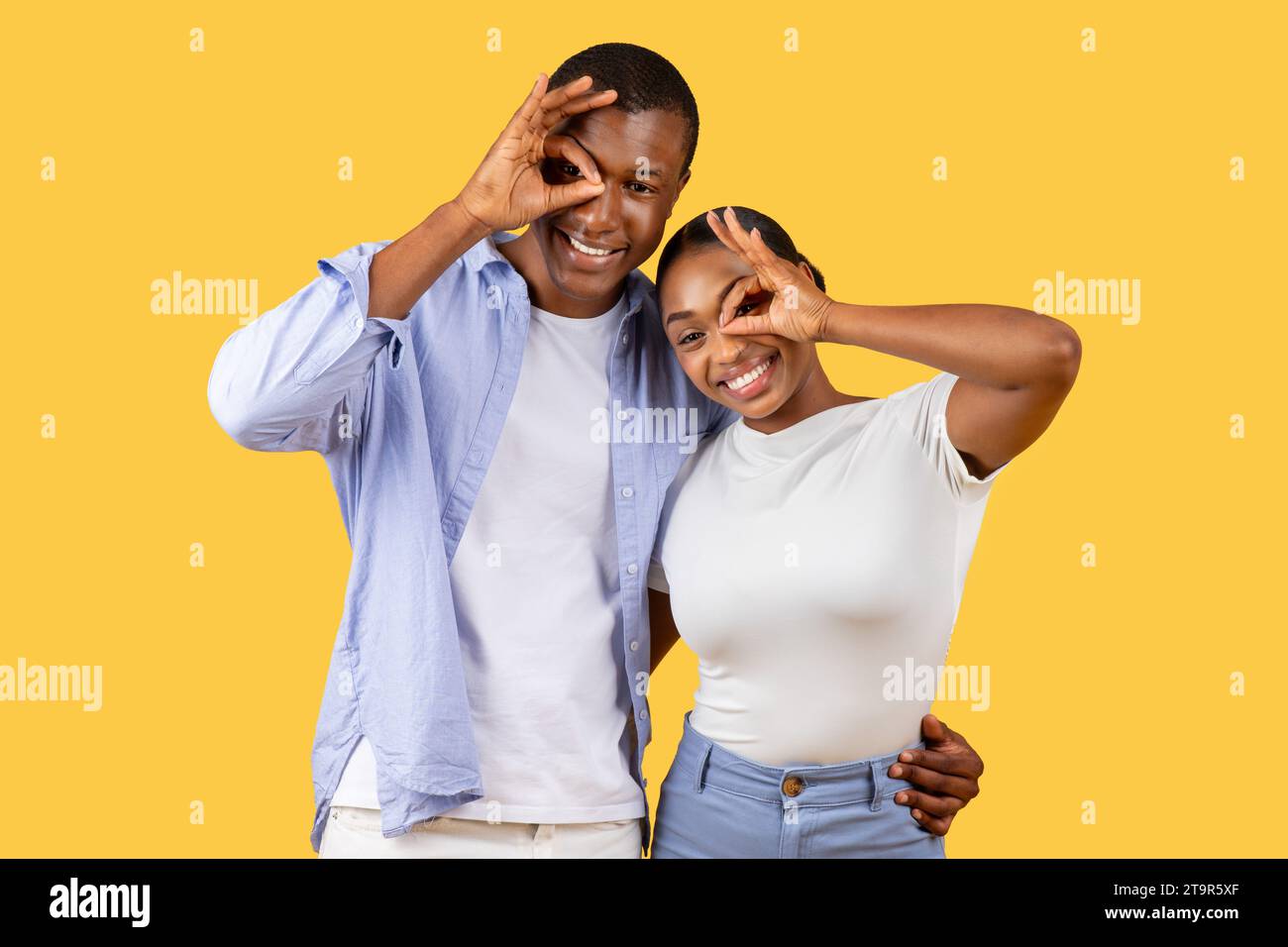 Happy black couple making fun hand gestures Stock Photo